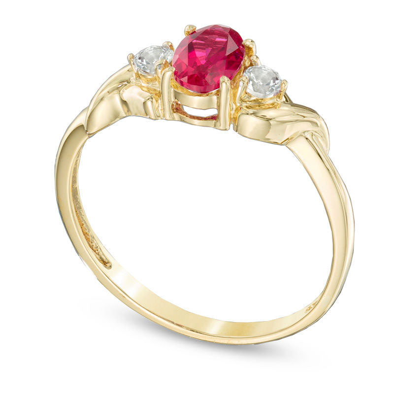 Oval Lab-Created Ruby and White Topaz Ring in Solid 10K Yellow Gold