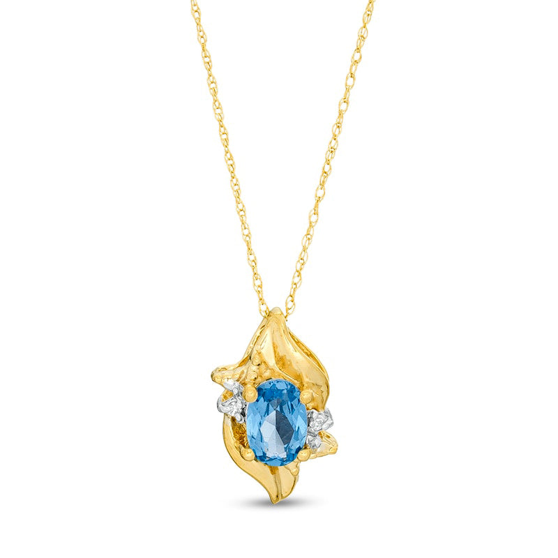 Oval Lab-Created Blue Zircon and Diamond Accent Flame Pendant in 10K Yellow Gold
