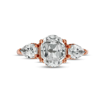 Oval White Lab-Created Sapphire and 0.17 CT. T.W. Diamond Frame Three Stone Engagement Ring in Solid 10K Rose Gold