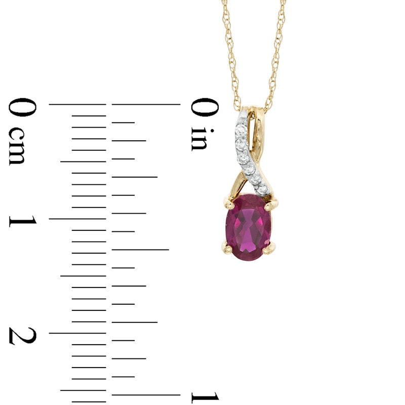 Oval Lab-Created Ruby and Diamond Accent Twist Pendant in 10K Yellow Gold