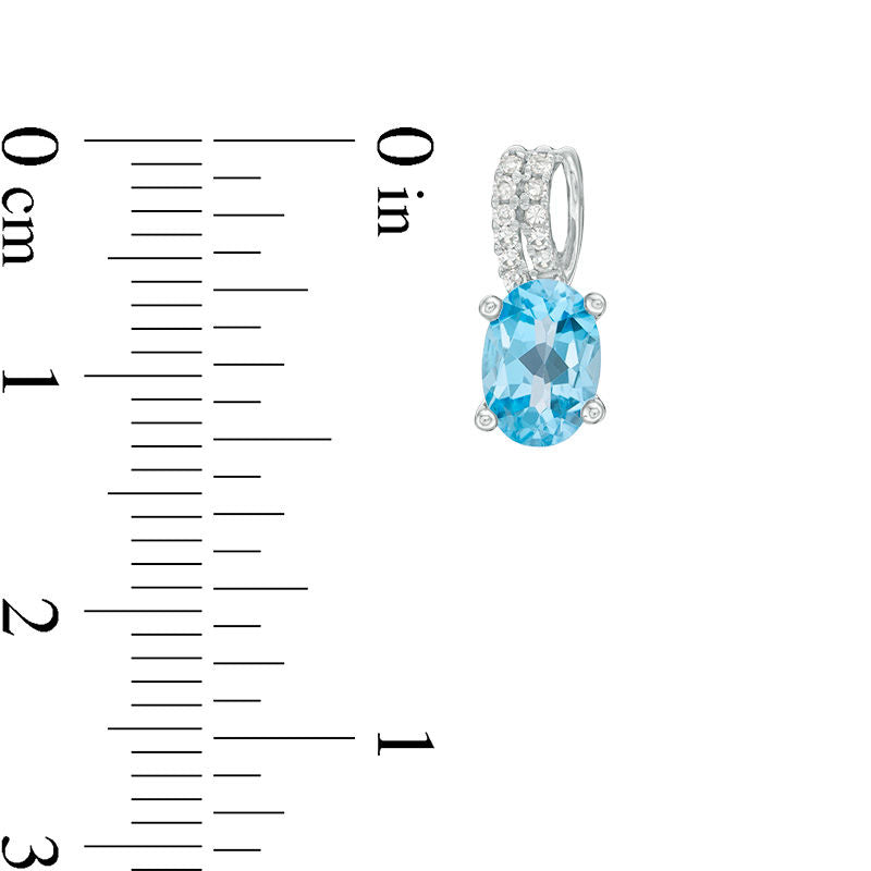 Oval Blue Topaz and 0.07 CT. T.W. Diamond Drop Earrings in 10K White Gold