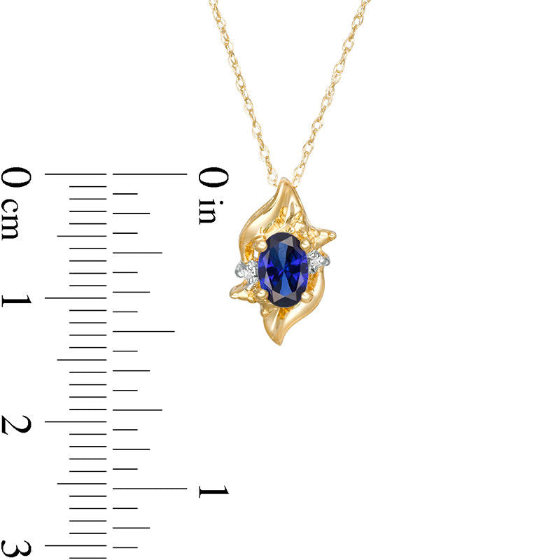Oval Lab-Created Blue Sapphire and Diamond Accent Flame Burst Pendant in 10K Yellow Gold