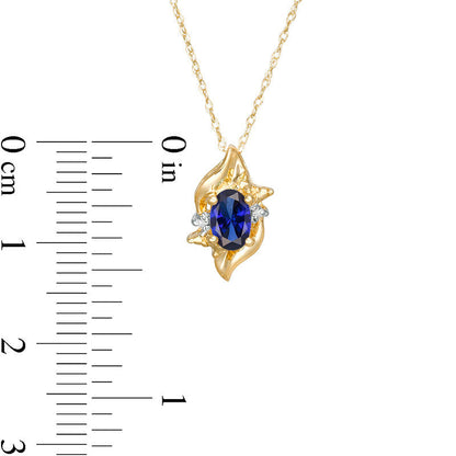Oval Lab-Created Blue Sapphire and Diamond Accent Flame Burst Pendant in 10K Yellow Gold