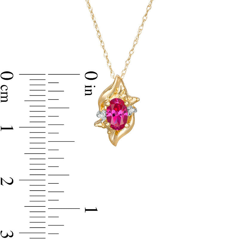 Oval Lab-Created Ruby and Diamond Accent Flame Burst Pendant in 10K Yellow Gold