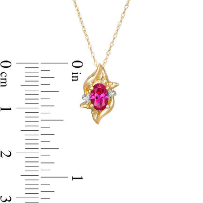 Oval Lab-Created Ruby and Diamond Accent Flame Burst Pendant in 10K Yellow Gold