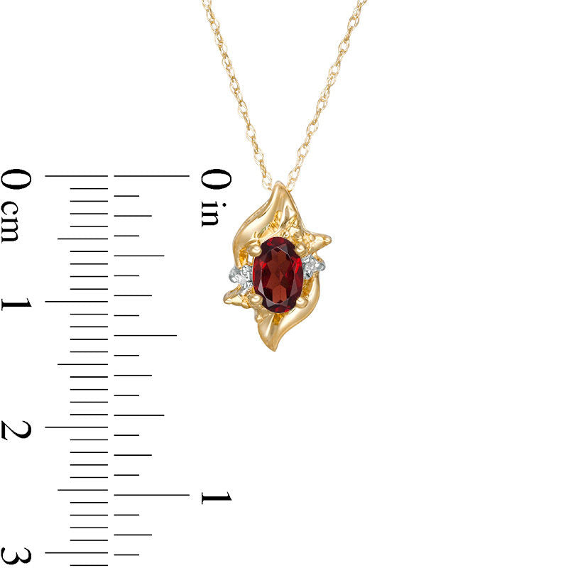 Oval Lab-Created Garnet and Diamond Accent Flame Burst Pendant in 10K Yellow Gold
