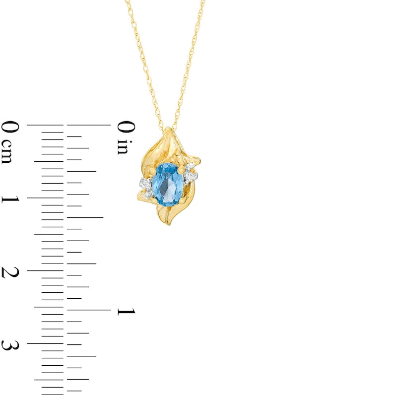 Oval Lab-Created Blue Zircon and Diamond Accent Flame Pendant in 10K Yellow Gold
