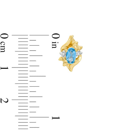 Oval Lab-Created Blue Zircon and Diamond Accent Flame Stud Earrings in 10K Gold