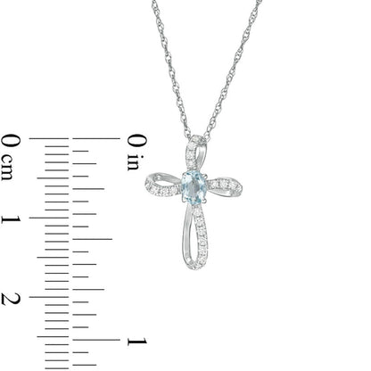 Oval Aquamarine and 0.1 CT. T.W. Natural Diamond Pinwheel Cross Pendant in 10K White Gold